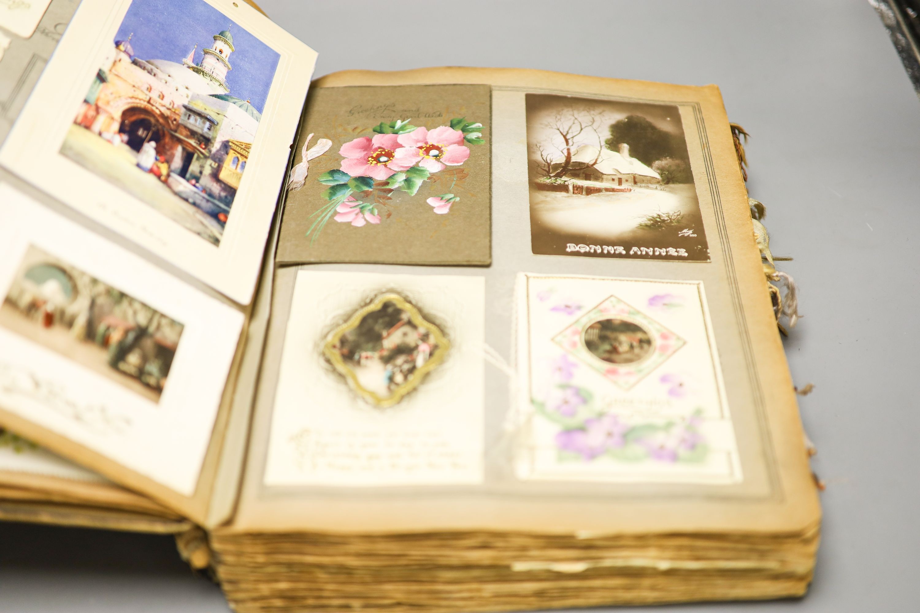 An early 20th century scrapbook and postcard album